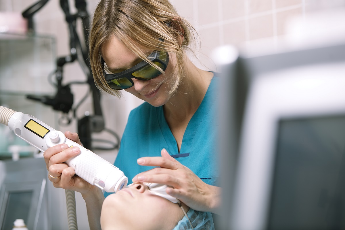 Woman having a laser skin treatment in a skincare clinic, a resurfacing technique for wrinkles, scars and solar damage to the skin of her face