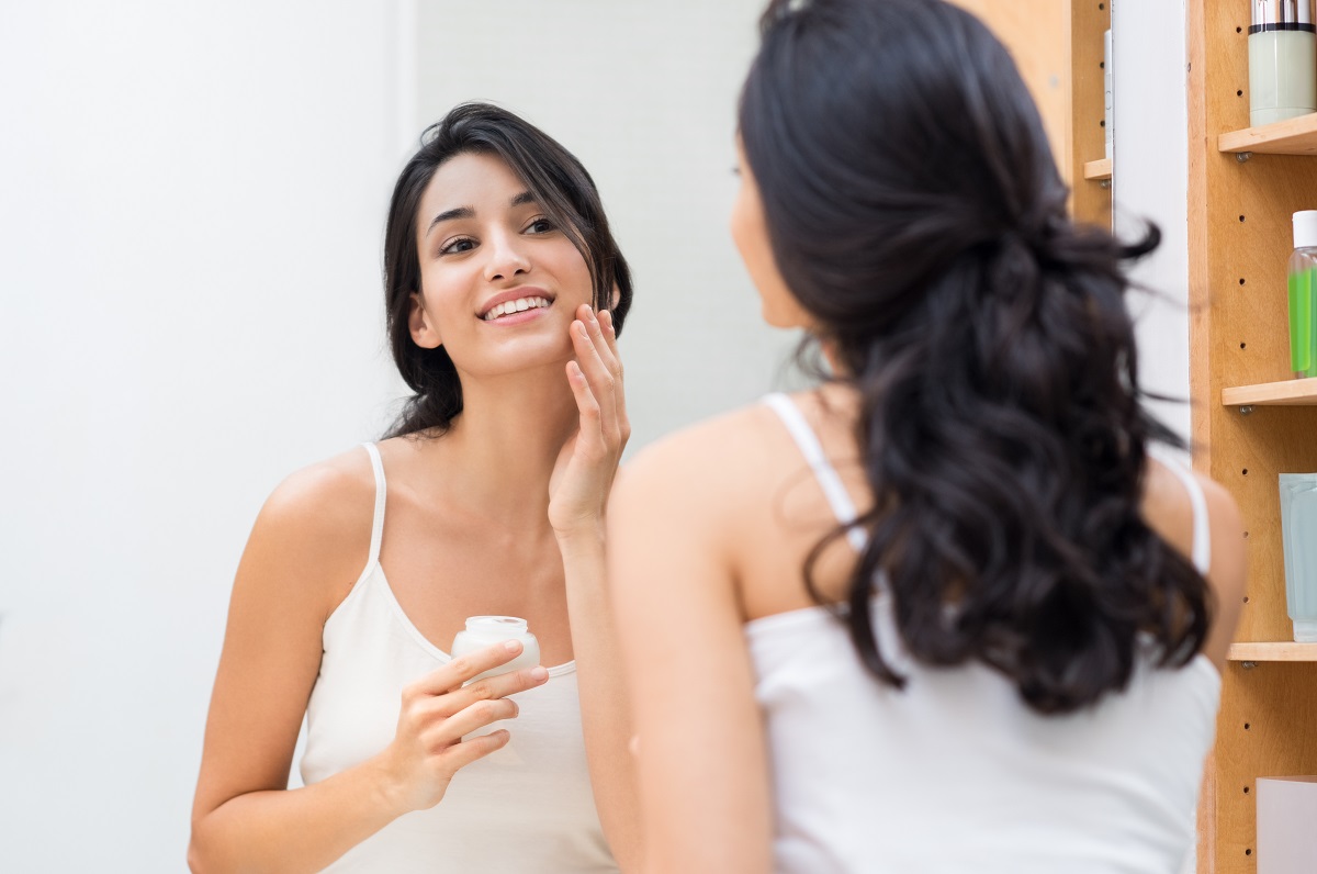 Woman putting cream skincare