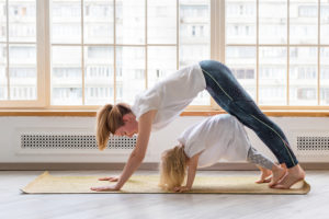 woman-doing-yoga-with-daughter