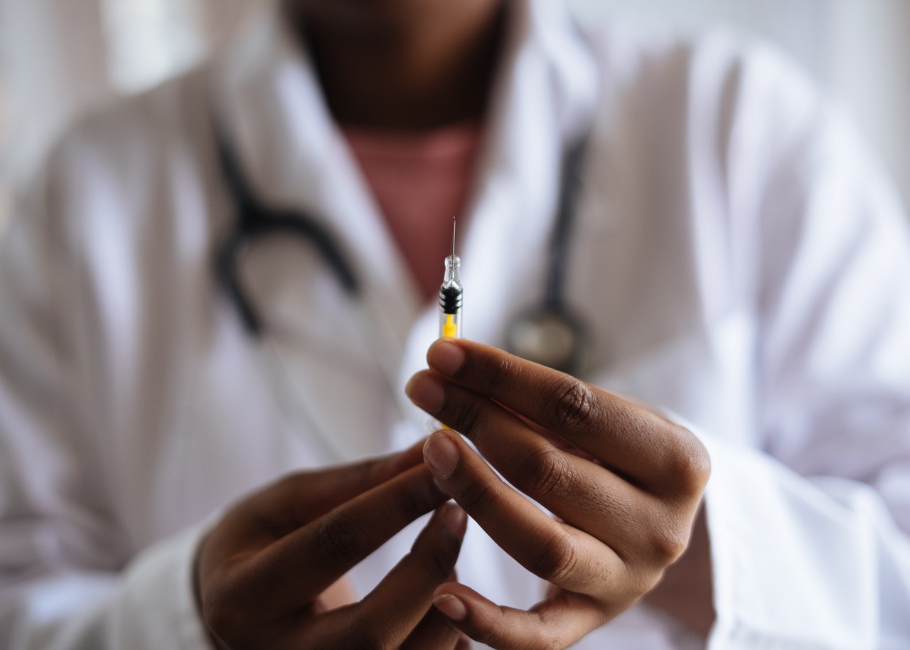 doctor holding syringe