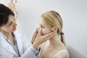 Doctor holding a patient's face