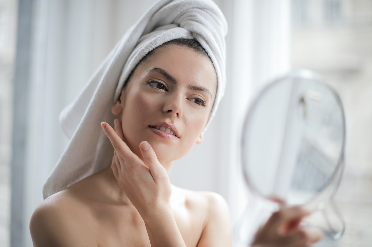 woman checking facial skin