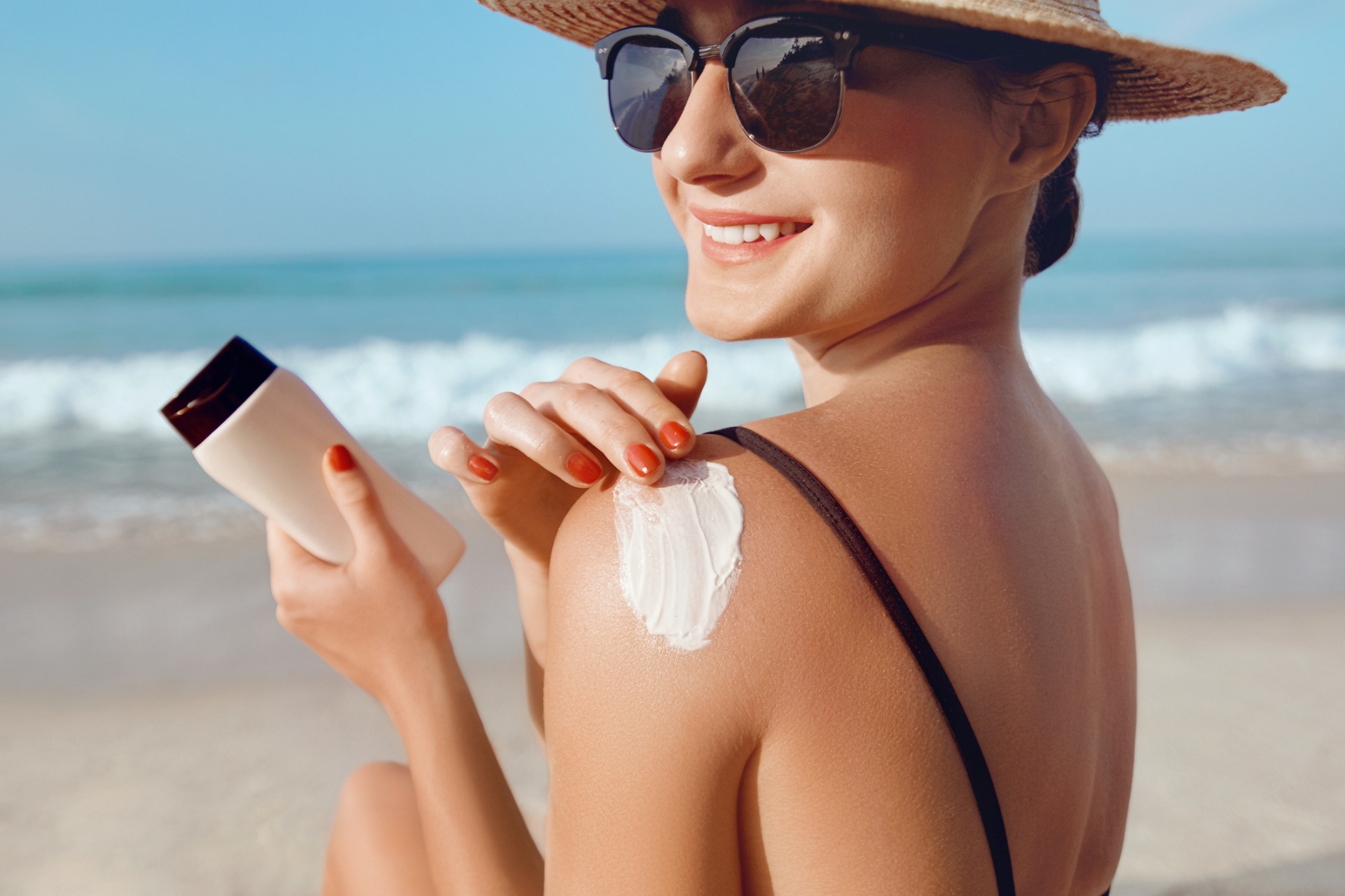 A woman applying sunscreen