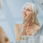 Woman-applying-skin-care-products-to-face
